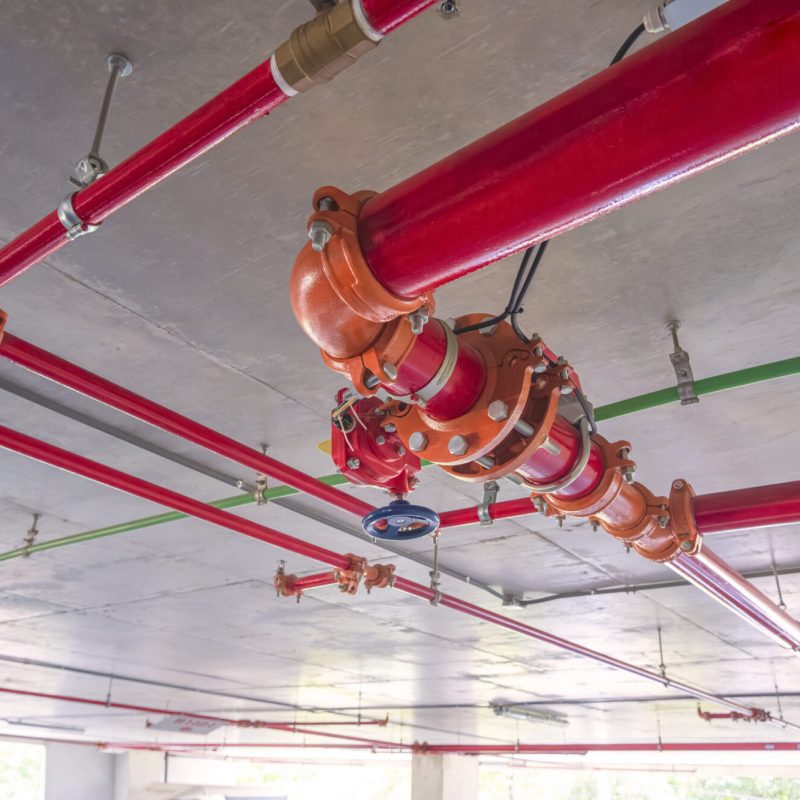 red-fire-protective-water-pipeline-system-on-concr-2025-03-11-14-12-25-utc